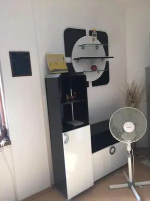 a room with a black and white cabinet and a chair at Blue Summer in Sunny Beach