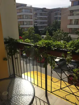 a balcony with a table and some plants on it at Blue Summer in Sunny Beach