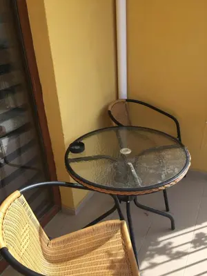 a glass table and chairs on a balcony at Blue Summer in Sunny Beach