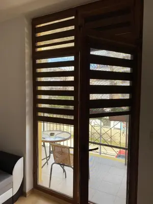 a room with a sliding glass door with a table and a patio at Blue Summer in Sunny Beach