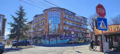 a stop sign on a city street with a building at Sunny Sands Studios in Burgas City