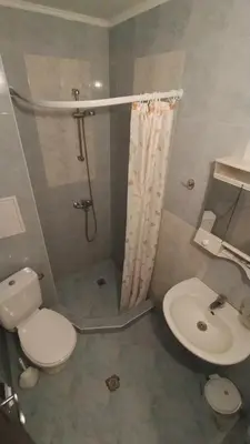 a bathroom with a shower and a toilet and a sink at Sunny Sands Studios in Burgas City
