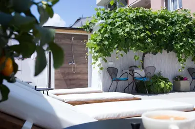 a patio with chairs and a table with plants at Ema Hotel in Sozopol