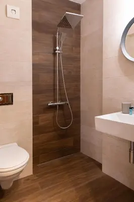 a bathroom with a shower with a toilet and a sink at Ema Hotel in Sozopol