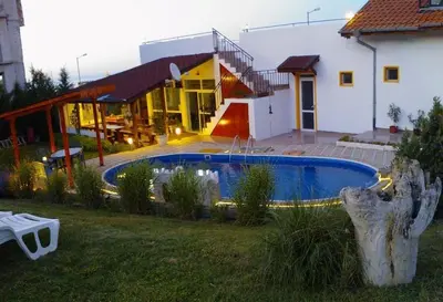 a pool in a yard next to a house at Guest House Evin Rai in Byala