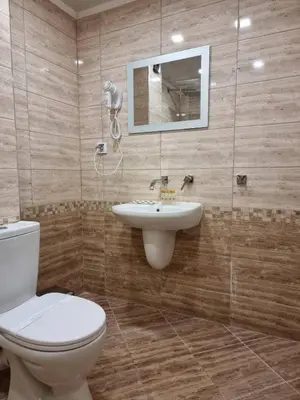 a bathroom with a toilet and a sink at Family Hotel Alfa Vita in Sozopol