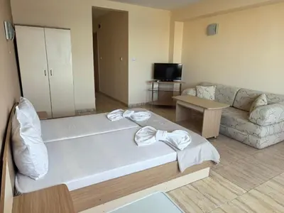a living room with a large bed and a couch at Family Hotel Alfa Vita in Sozopol