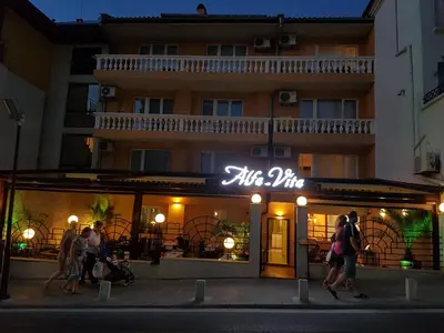 people walking in front of a restaurant at night at Family Hotel Alfa Vita in Sozopol