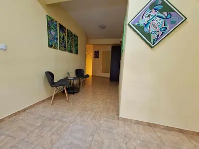 a hallway with two chairs and a table on a wall at Guest House Starata Kushta in Lozenets