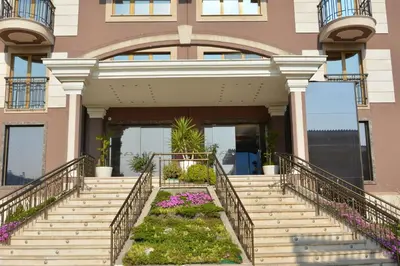 a building with stairs and flowers in front of it at Golden Rainbow Beach Hotel in Sunny Beach