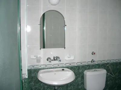 a bathroom with a sink and a mirror and a toilet at Hotel Levteri in Primorsko