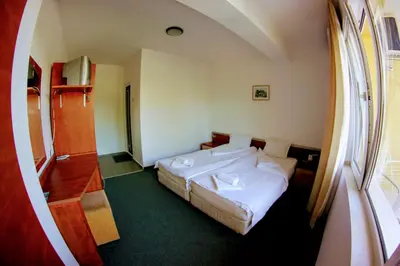 a hotel room with a bed and a window at R&G Hotel in Nesebar