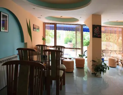a dining room with chairs and a table in a room at R&G Hotel in Nesebar