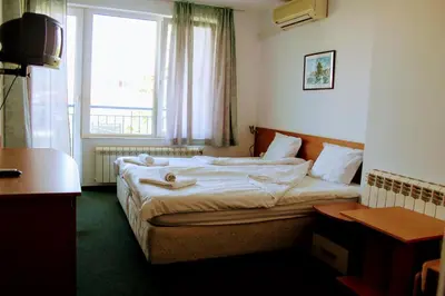 a hotel room with a bed and a window at R&G Hotel in Nesebar