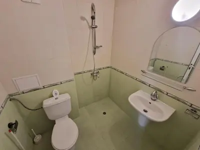 a bathroom with a toilet and a sink at Family Hotel Diana in Tsarevo