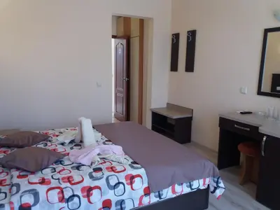 a bedroom with a bed with flip flops on it at Hotel Sirena in Primorsko