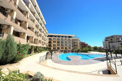 a swimming pool in the middle of a building at Menada Luxor Apartments in Sveti Vlas