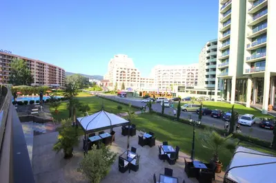a view of a city street with tables and buildings at Menada Sunny Beach Plaza Apartments in Sunny Beach