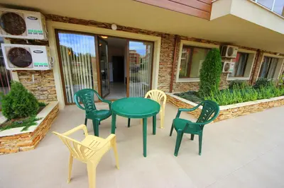 a group of chairs and a table on a patio at Menada Horyzont Apartments in Sozopol