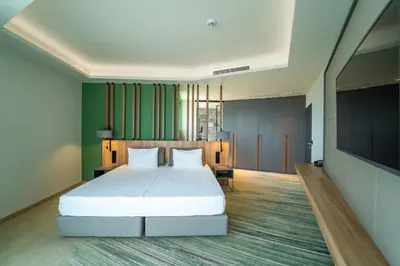 a bedroom with a bed and a flat screen tv at HVD Reina del Mar - Premium Spa Service & Free Parking in Obzor