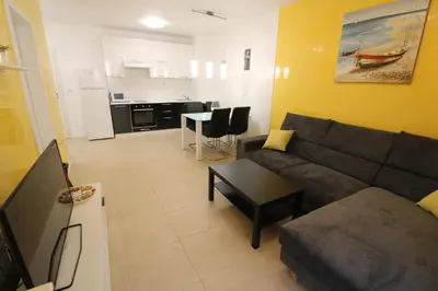 a living room with a couch and a table at Menada Kavaci Sozopol Apartments in Sozopol