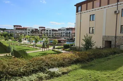 a view of a park with buildings in the background at Menada Kavaci Sozopol Apartments in Sozopol