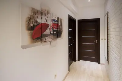 a hallway with a painting of a red umbrella at City Apartments Triumph in Varna City