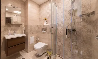 a bathroom with a shower and a toilet and a sink at City Apartments Triumph in Varna City