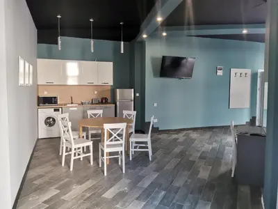 a kitchen and dining room with a table and chairs at Rose Garden Omax Apartments in Sunny Beach