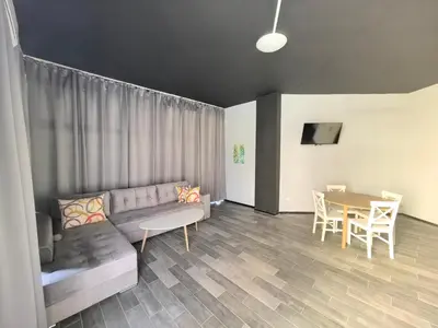 a living room with a couch and a table at Rose Garden Omax Apartments in Sunny Beach