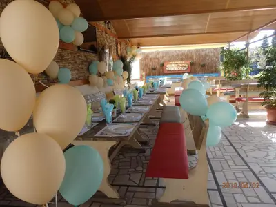 a row of tables with balloons on the wall at Guest house Napoli in Ravda
