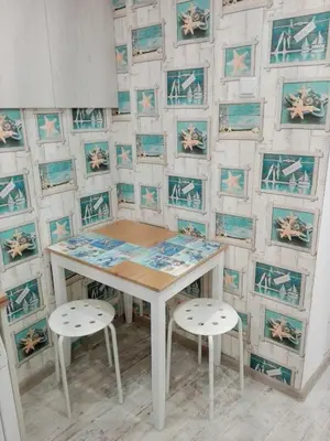 a table and two stools in front of a wall at INFINITY Blue 1 in Burgas City