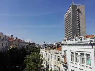 a tall building in the background of a city at INFINITY Blue 1 in Burgas City