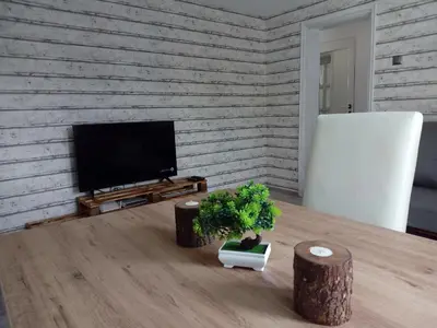 a living room with a table and a television at INFINITY Blue 1 in Burgas City