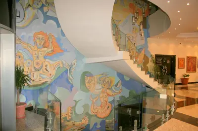a staircase with a mural on the wall at Aparthotel VRIS in Tsarevo