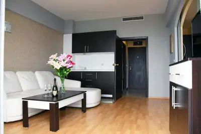 a living room with a white couch and a table at Aparthotel VRIS in Tsarevo