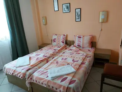 two beds sitting next to each other in a room at Guest House Nikolovi in Lozenets