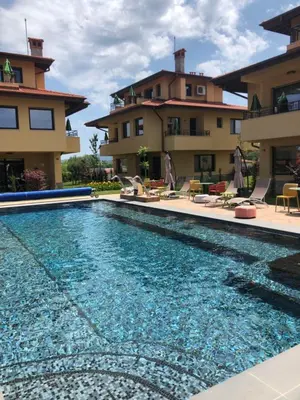 a swimming pool in front of a house at Villa EM in Lozenets