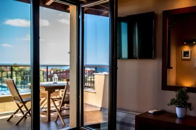 a room with a view of a balcony with a table at Villa EM in Lozenets
