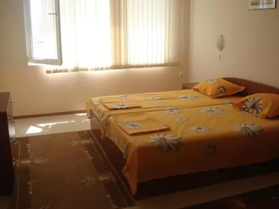 two beds in a bedroom with a window at Villa Rouge in Sozopol
