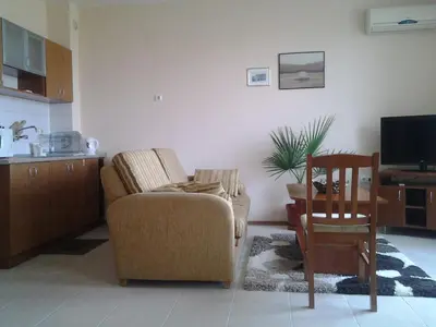 a living room with a couch and a chair and a table at Villa Rouge in Sozopol