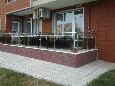 a balcony with tables and chairs on a building at Villa Rouge in Sozopol