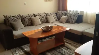 a living room with a couch and a table at Villa Rouge in Sozopol