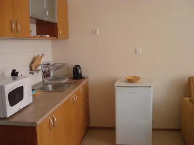 a kitchen with a white microwave and a refrigerator at Villa Rouge in Sozopol