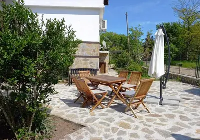 a table and chairs and an umbrella on a patio at Villa Kalina in Lozenets