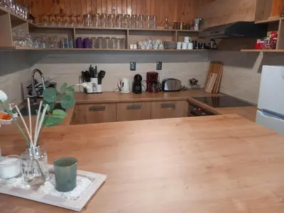 a kitchen with a wooden counter top with a table at Villa Kalina in Lozenets
