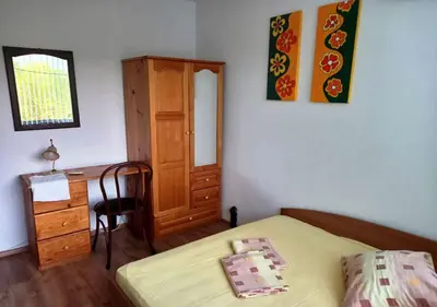a bedroom with a bed and a desk and a chair at Villa Kalina in Lozenets