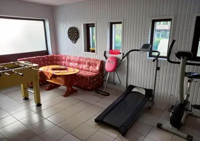 a living room with a couch and a table and a treadmill at Villa Kalina in Lozenets