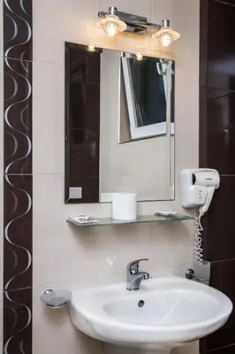 a bathroom with a sink and a mirror at Семеен хотел Адена in Chernomorets