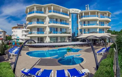 a hotel with a swimming pool in front of a building at Семеен хотел Адена in Chernomorets